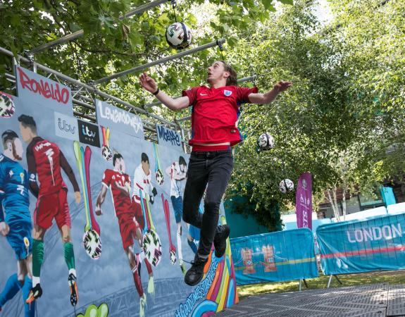 Young person jumping and heading a ball