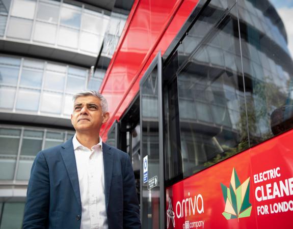 Sadiq Khan standing in front of an electric double decker bus