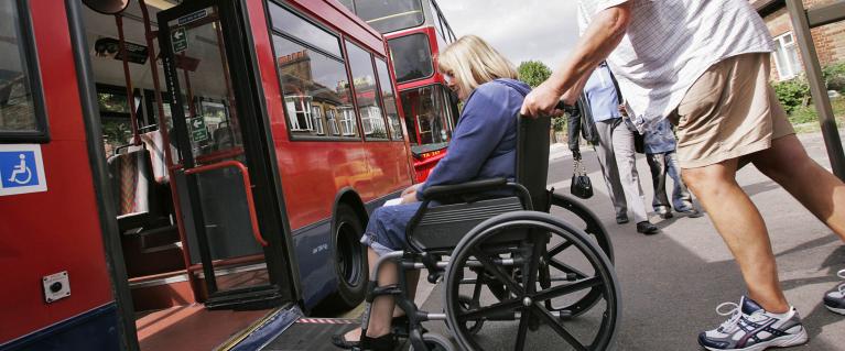 A wheelchair user accessing a bus