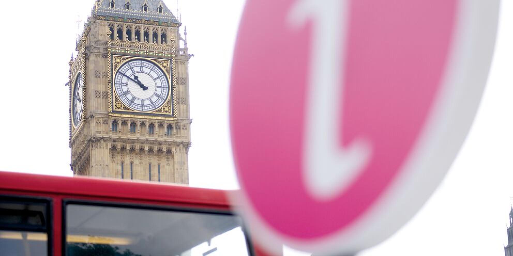 Big Ben with London bus and information sign