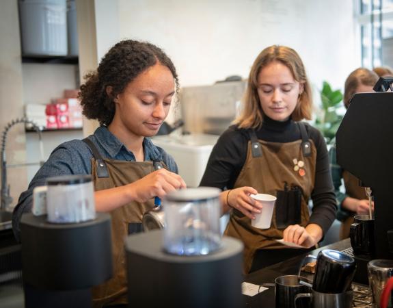 Two people working in coffee shop