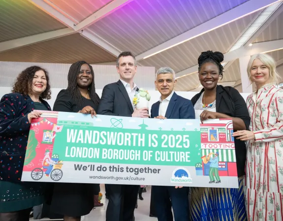 Group of people holding a banner that reads 'Wandsworth is 2025 London Borough of Culture'