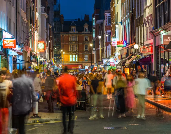Crowds on busy London street at night