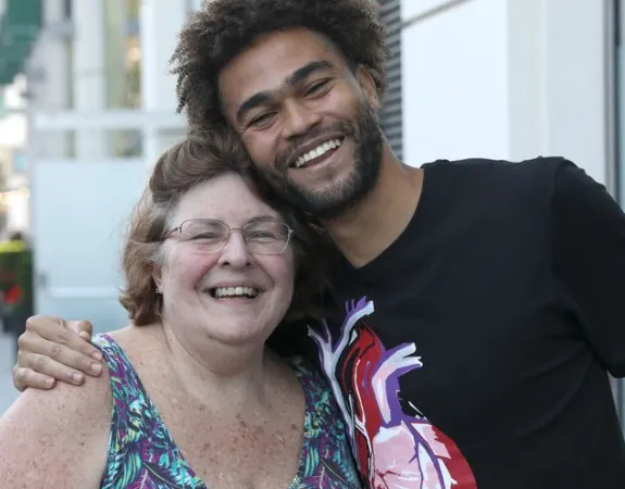 Young man hugging woman