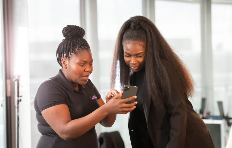 Two young women looking at a mobile phone