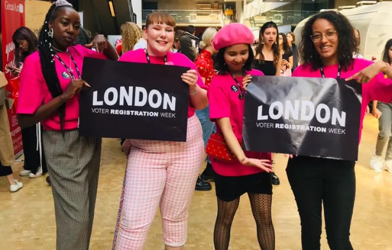 A group of young people holding 'London Voter Registration Week' banners