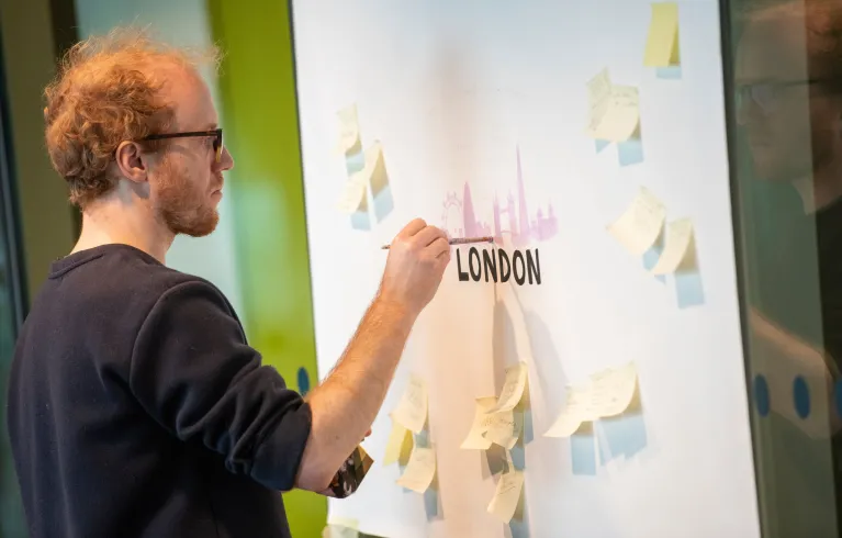 Man drawing on a board at Creative Enterprise Zone event