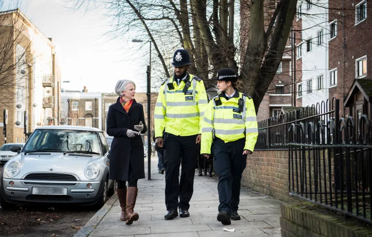 Sophie Linden walking with two police officers