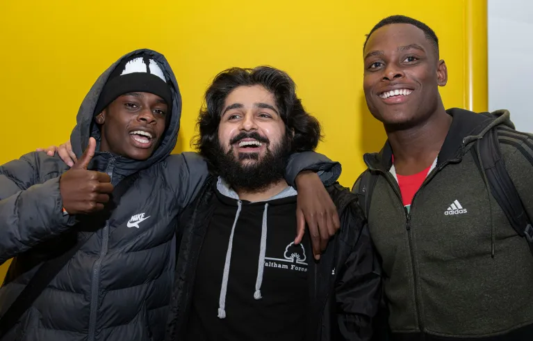 3 young people smiling at the camera