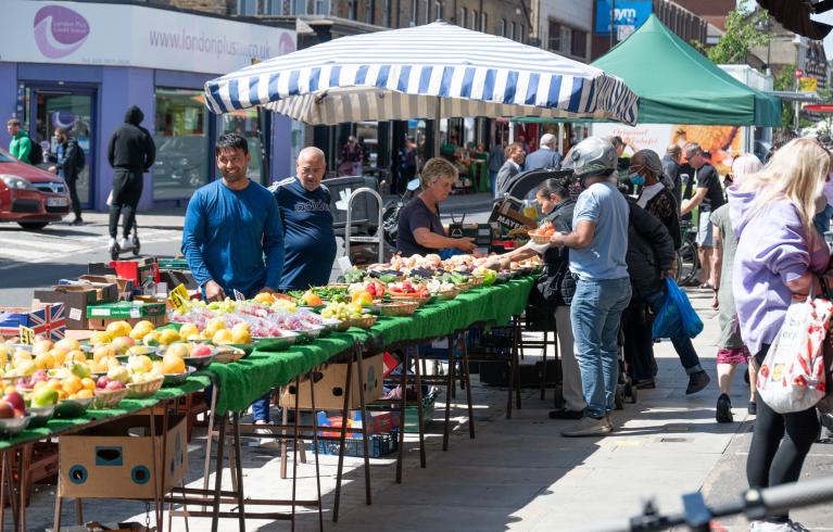 Traders selling goods on North End Road Market in Hammersmith and Fulham