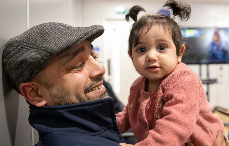 Father and child sitting down.