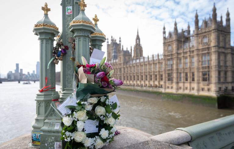 Floral tributes on Westminster Bridge with the Palace of Westminster in the background