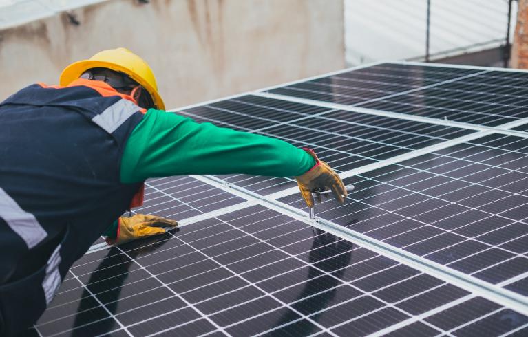 Engineer installing solar panels on a rooftop