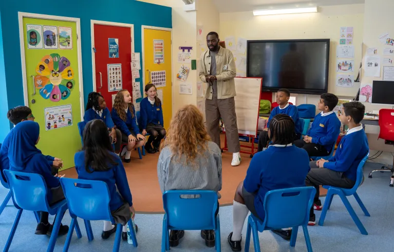 Teacher in a classroom with school children