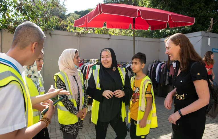 Photo showing volunteers in conversation with a family at Lewisham Donation Hub