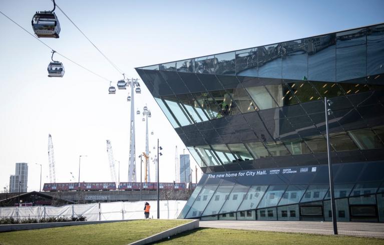 Photo of the City Hall building in East London with cable cars on wires going past the side of the building