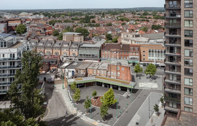 Wide shot of Lyon Road Public Square with Harrow Road town centre and high street in the background