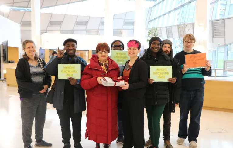 Zoë Garbett stands with residents of the Lesnes estate at City Hall