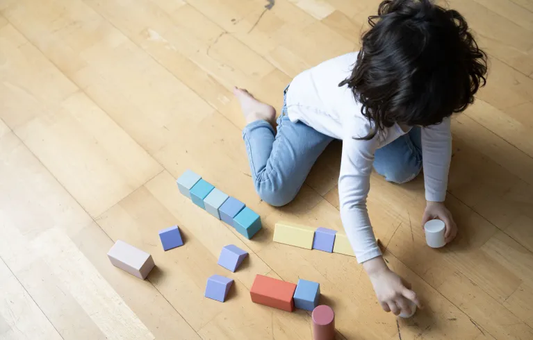Child playing with wooden toys