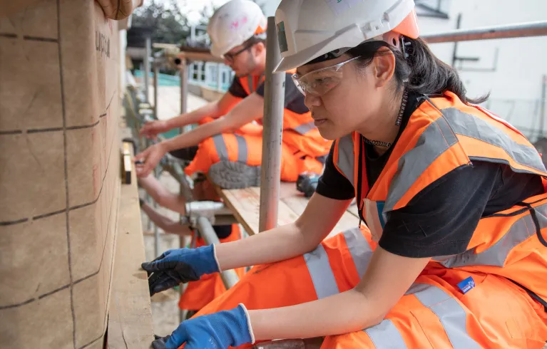 construction worker fitting wood