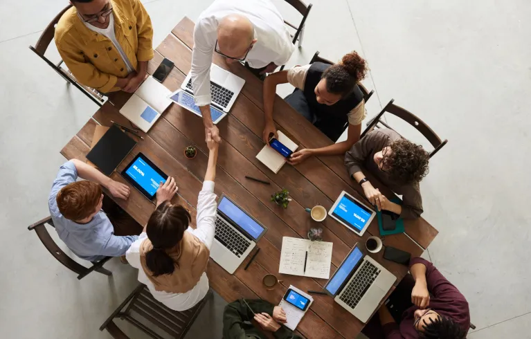 People around table at team meeting