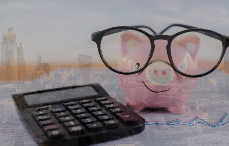 Photo of London with budgeting materials layered on top