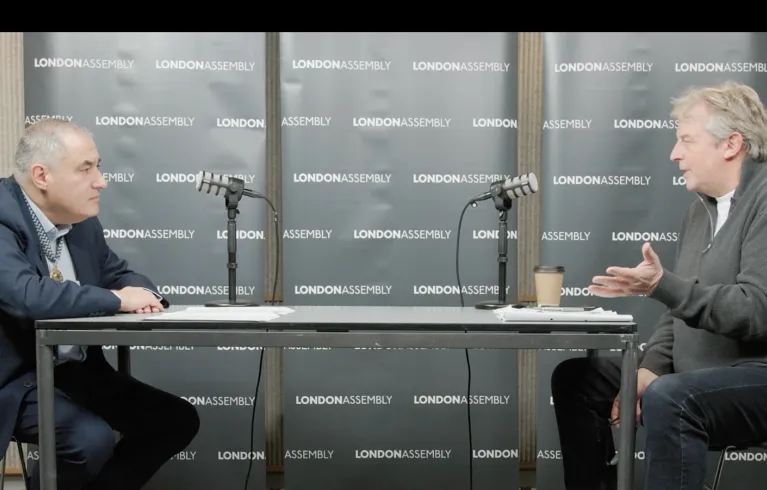 two men talking into mic