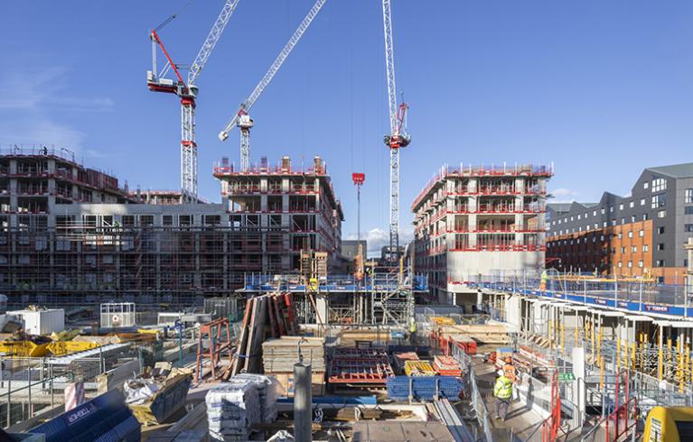 A construction site in London including crane and construction site workers