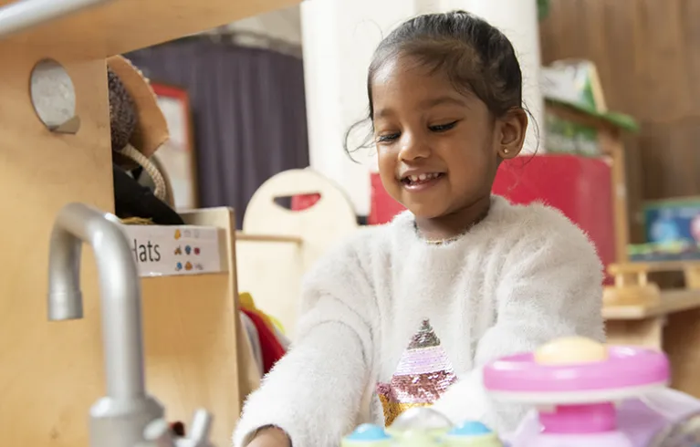 A young child in classroom/playroom
