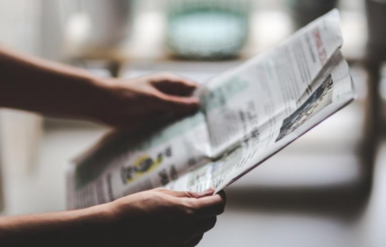 Person holding a newspaper