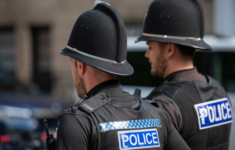 Two police officers walk side by side