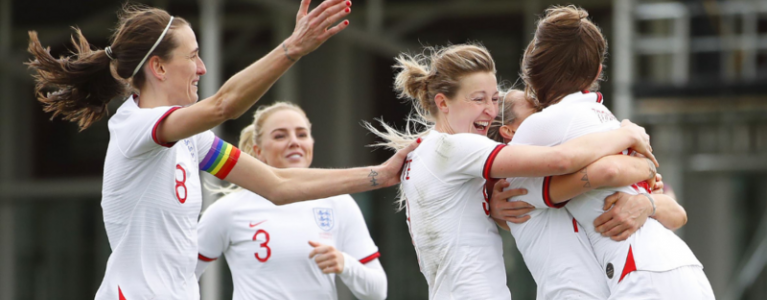 England women's national football team hugging each other at a match
