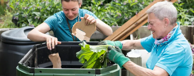 Two people recycling food