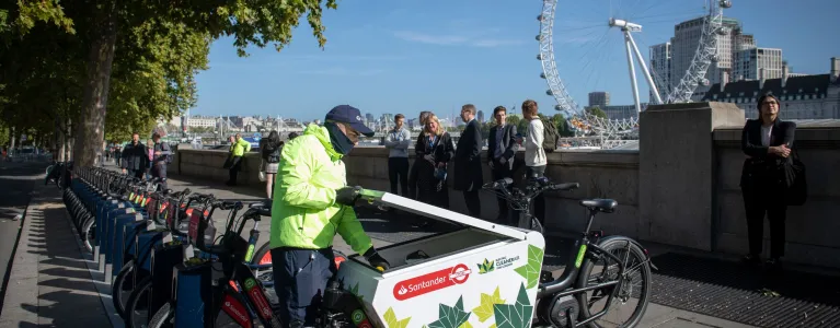 a person at a row of electric bikes