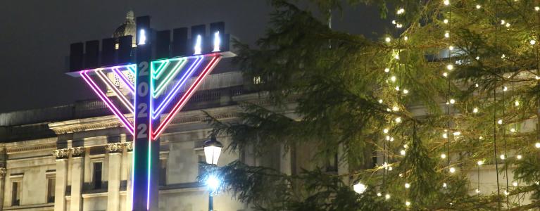 Giant menorah lit in purple colour for Chanukah 2022 from distance