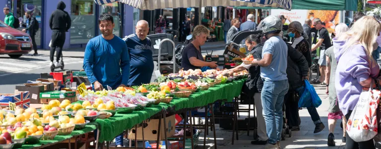 Traders selling goods on North End Road Market in Hammersmith and Fulham