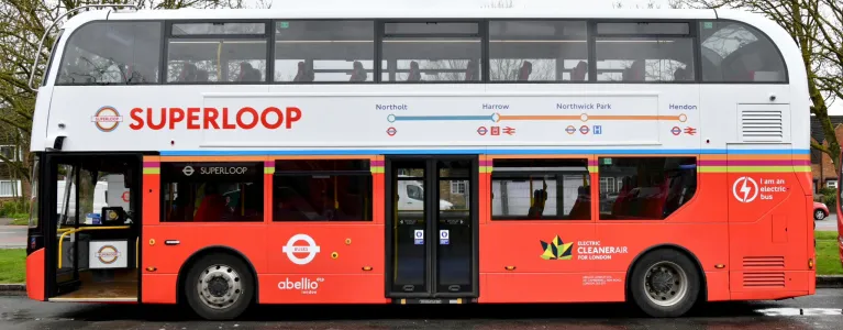 A double decker London bus with the superloop roundel on the side and the word Superloop in large red letters