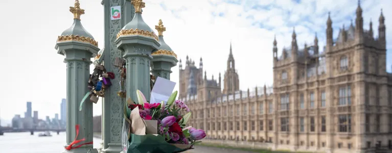 Floral tributes on Westminster Bridge with the Palace of Westminster in the background