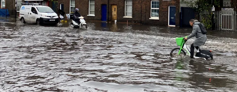 Bike going through surface water on London road