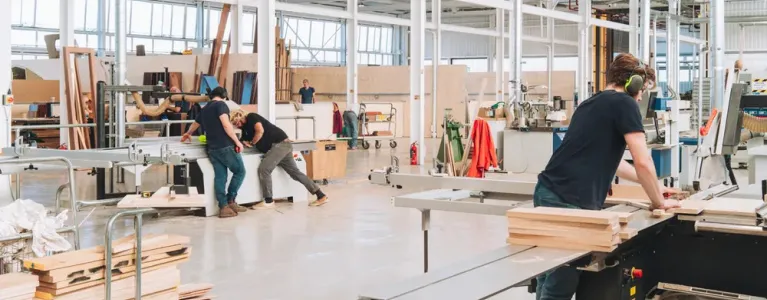 Wood workers using wood working equipment and tools
