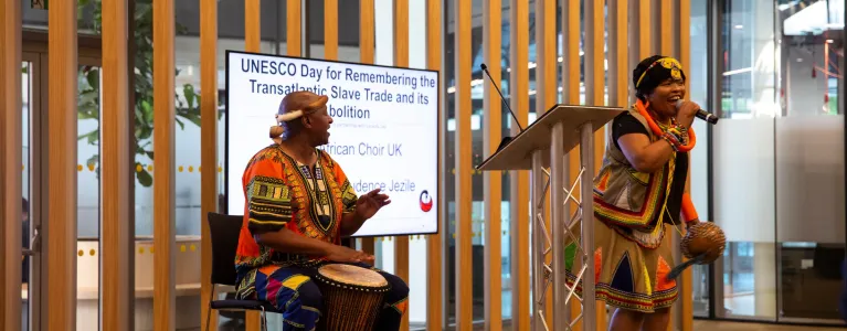 A male and female performer on stage at City Hall
