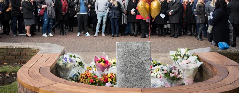 People gather at a memorial in Market Square on Central Parade for a ceremony to remember the victims of the crash on the first anniversary.