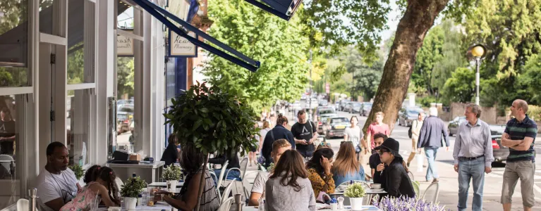 People sitting outside a café in Hampstead Heath.