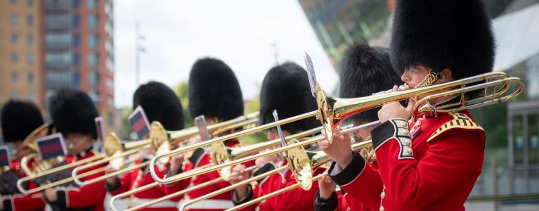  Army musicians playing the trumpet outside City Hall
