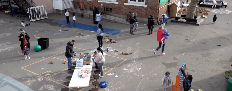 Children and parents playing together at Surrey Square Primary School playground