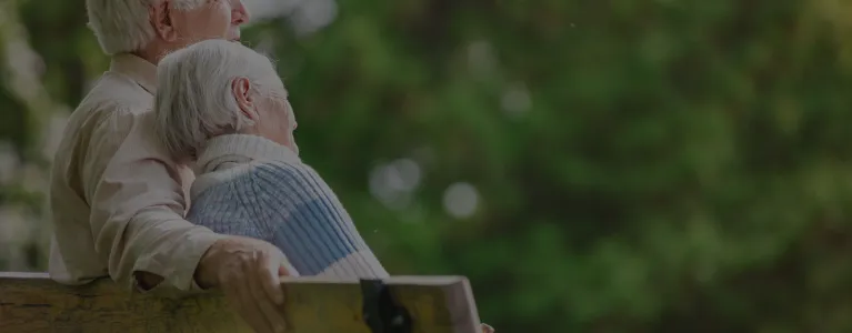 elderly white couple on a bench