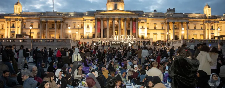 Group of people seating on the ground breaking fast for Ramadan