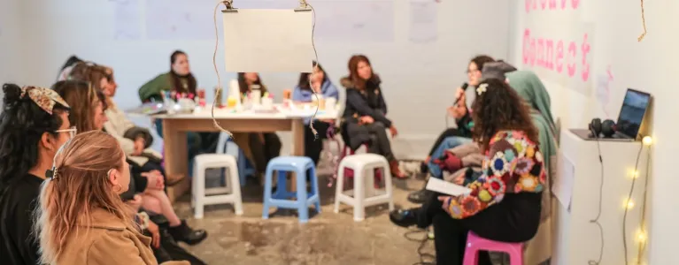 People sitting during an artist panel at an exhibition opening evening