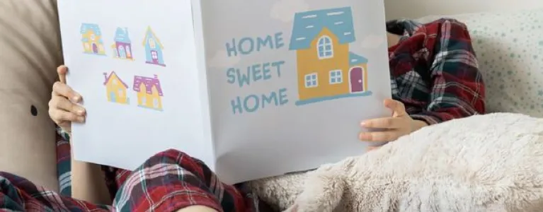 Children reading a book called 'Home Sweet Home'