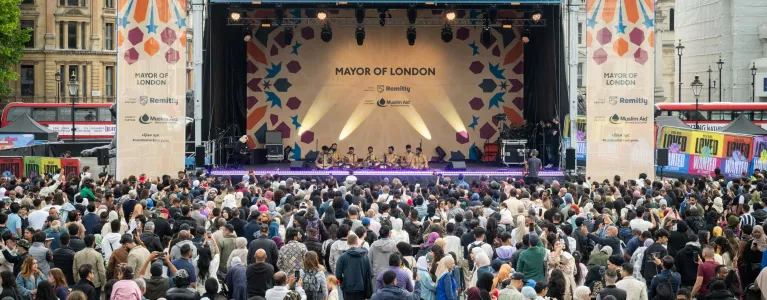 crowd of people in front of a stage at Trafalgar Square